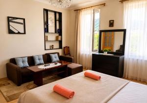 a living room with two beds and a couch at Mountain Home Inn-Guesthouse in Lagodekhi +30 photos