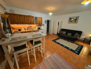 a kitchen and living room with a table and a couch at B59 mini in Budakalász