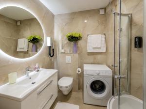 a bathroom with a sink and a washing machine at Villa Jurisic in Tučepi +17 photos