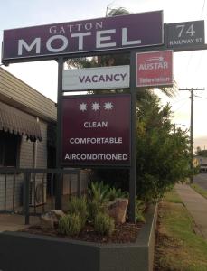 una señal para un concesionario de coches frente a una tienda en Gatton Motel, en Gatton