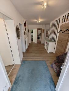a hallway of a home with a blue rug at Kurhotel Wiedenmann in Bad Wörishofen