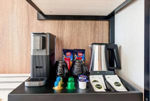 a counter top with a coffee maker and a blender at B&B HOTEL A Coruña Aeropuerto in Culleredo