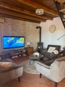 a living room with a large flat screen tv at Villa Rustica in Pokrovnik