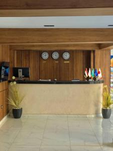 a lobby with clocks on the wall and a counter at Pyramids view M in Cairo