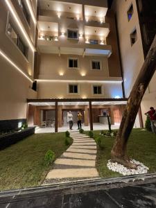 a building with a tree in front of it at Pyramids view M in Cairo