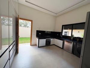 a kitchen with a black counter top and appliances at Villa Émeraude in Marrakesh
