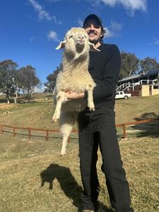 a woman is holding a sheep in a field at Mountain View Farm in Portland +42 photos