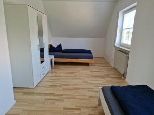 a bedroom with a bed and a mirror at Apartment Stark in Merkendorf