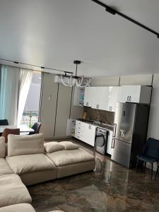 a living room with a couch and a kitchen at ,,KaKalo'' Apartments in Kobuleti
