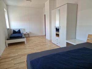a bedroom with a bed and a large mirror at Apartment Stark in Merkendorf