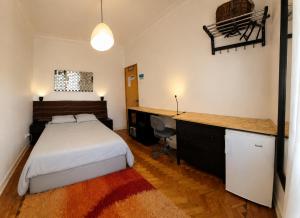 a bedroom with a bed and a desk in it at Parque das Nações Room in Lisbon