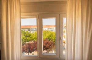 a window with a view of a building at Parque das Nações Room in Lisbon