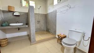 a bathroom with a shower and a toilet and a sink at Villa La Pommone in Somone +59 photos