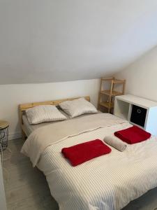 a bedroom with two beds with red towels on them at Proche métro Line 4 RER B in Bagneux