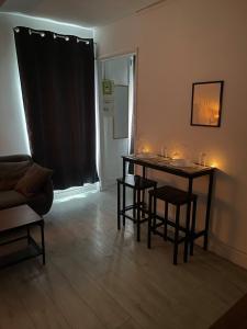 a living room with a table with candles on it at Proche métro Line 4 RER B in Bagneux +1 photo