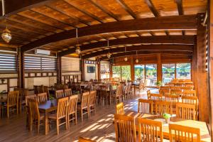 a dining room with wooden tables and chairs at Apart Hotel Llolla in Ulcinj
