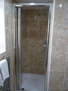 a shower with a glass door in a bathroom at The Gatwick White House Hotel in Horley +96 photos
