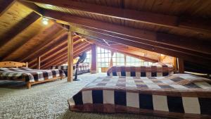 a room with two beds in a attic at El Peregrino in Cota