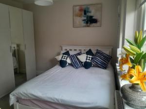 a bedroom with a bed with blue and white pillows at Seville Grove in Kilkenny