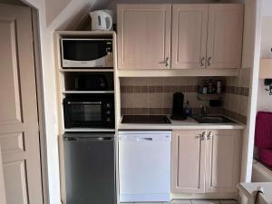 a kitchen with white cabinets and white appliances at Maison 6 pers. avec Terrasse Privée, 3 Pièces en Duplex – Wifi & Animaux Admis - FR-1-382-119 in Grospierres