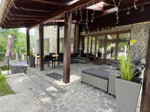 an outdoor patio with a table and chairs at Vila Mama Jana in Buşteni
