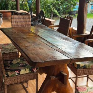 a wooden table with chairs and a wooden tableitures at Hotel Borari in Alter do Chao