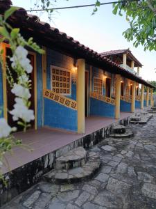 a building with blue and yellow paint on it at Recanto Das Marés in Jacumã