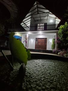 a house with a large wooden door and a stone yard at Emerald Mirror in Anuradhapura +5 photos