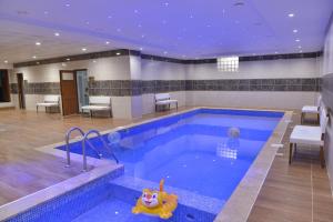 a large swimming pool with a toy in the middle at Grand Beyaz Saray Otel in Duzce