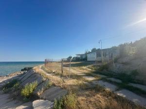 a house on the beach next to the ocean at домик у самого моря in Odesa