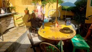 a woman sitting at a table with a hat on it at Casa Ricardo in Svendborg