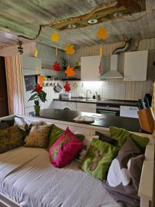 a couch with colorful pillows in a kitchen at Unser Hasenstall in Wietzendorf