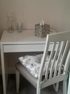 a white desk with a chair and a box of tissues at Seville Grove in Kilkenny