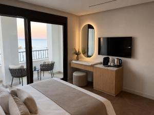 a bedroom with a bed and a desk with a television at Apartments Eneida in Ulcinj +135 photos