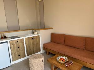 a living room with a couch and a table at Alos Suites in Verga Kalamata +101 photos