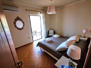 a small bedroom with a bed and a window at House M A R Y in Pefkali