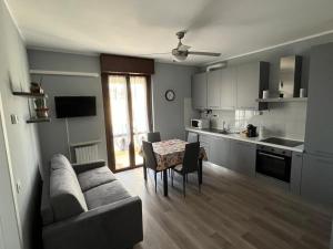 a kitchen and a living room with a couch and a table at bilocale con NETFLIX INCLUSO in Lodi