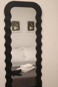 a mirror frame with a bed in a bedroom at Dany's studio central xanthi in Xanthi