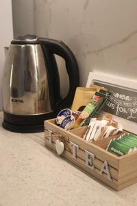 a tea kettle and a wooden box on a counter at Dany's studio central xanthi in Xanthi +9 photos