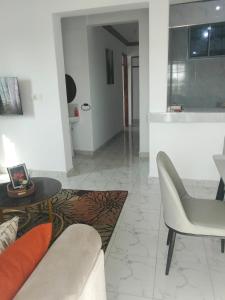 a living room with a couch and a table at MahaliaLuxuryStays in Malindi
