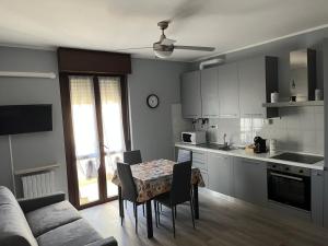 a kitchen with a table and chairs and a couch at bilocale con NETFLIX INCLUSO in Lodi +3 photos