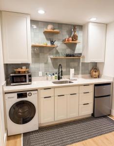 a kitchen with white cabinets and a dishwasher at Kona Hang Loose Studio in Kailua-Kona +5 photos