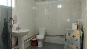 a bathroom with a toilet and a sink at Akmuz House in Ak-Muz +20 photos
