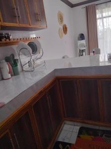 a kitchen with wooden cabinets and a counter top at MahaliaLuxuryStays in Malindi