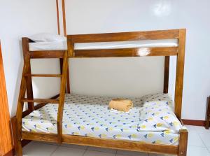 a bunk bed with a pillow on the bottom bunk at Queen's Guest House in El Nido +12 photos