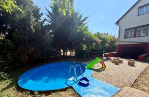 a small pool with a swing and a playground at Balatonfölvári nyaraló in Balatonföldvár