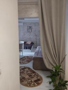 a living room with a couch and a table at Solid House - Sunrise Apartment in Mamaia