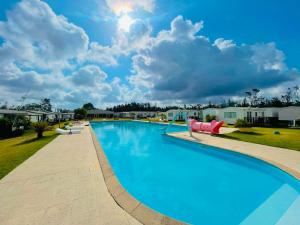a large swimming pool at a resort at Vickys Walls Bungalow in Pataias