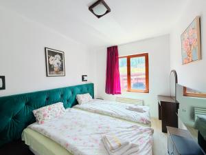 a bedroom with two beds and a green couch at VIP Complex in Sarnitsa