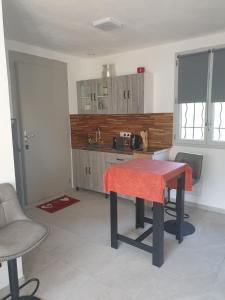 a kitchen with a table in the middle of a room at Independent studio Varages in Varages